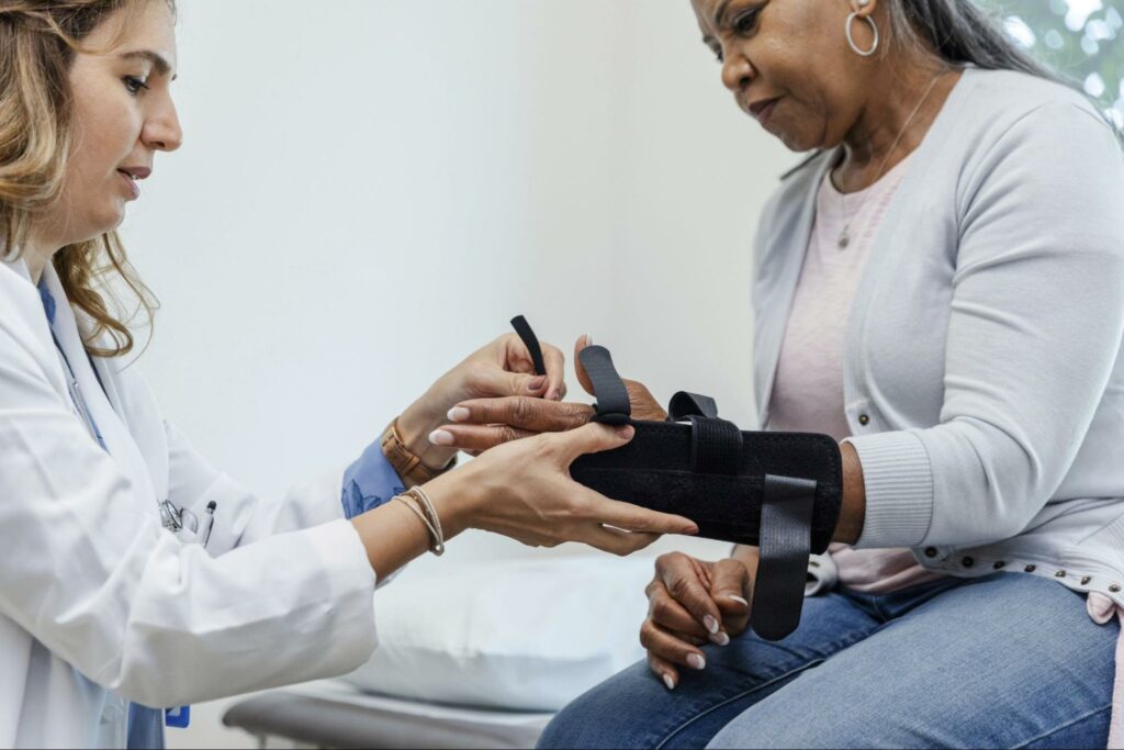 doctor-helping-woman-with-personal-injury-to-wrist