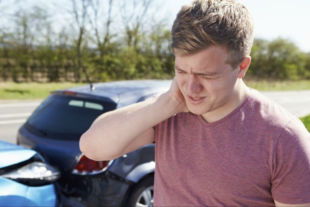 man-rubbing-neck-after-being-rear-ended