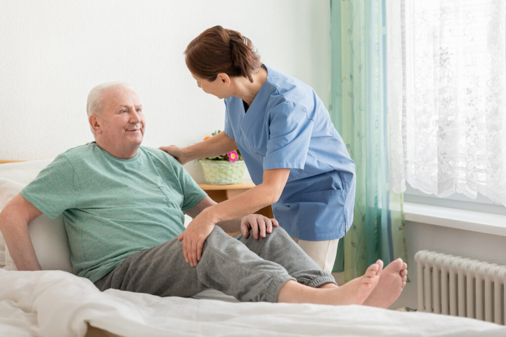 nurse-moving-elderly-man-to-avoid-bedsores-at-nursing-home