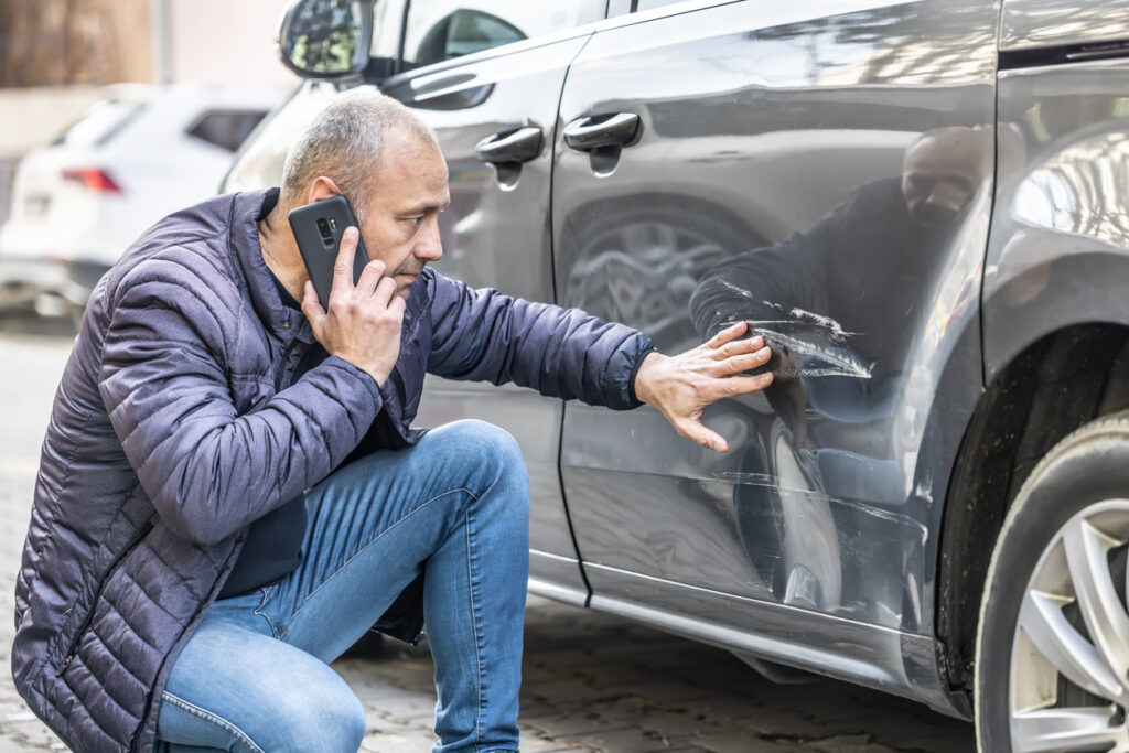 man-inspecting-damage-from-SC-automobile-accident